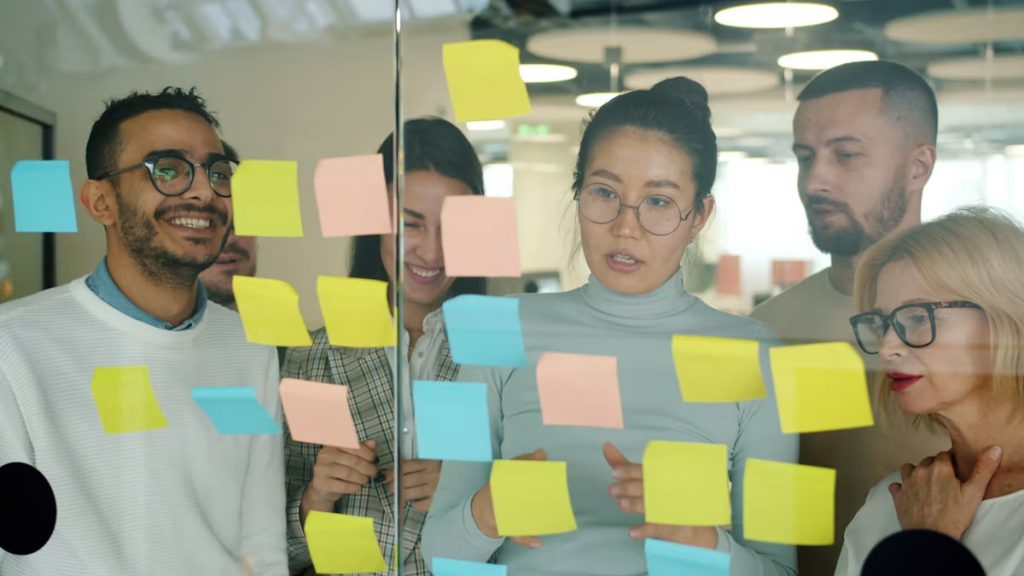 Team of colleagues brainstorming with sticky notes during a workshop session